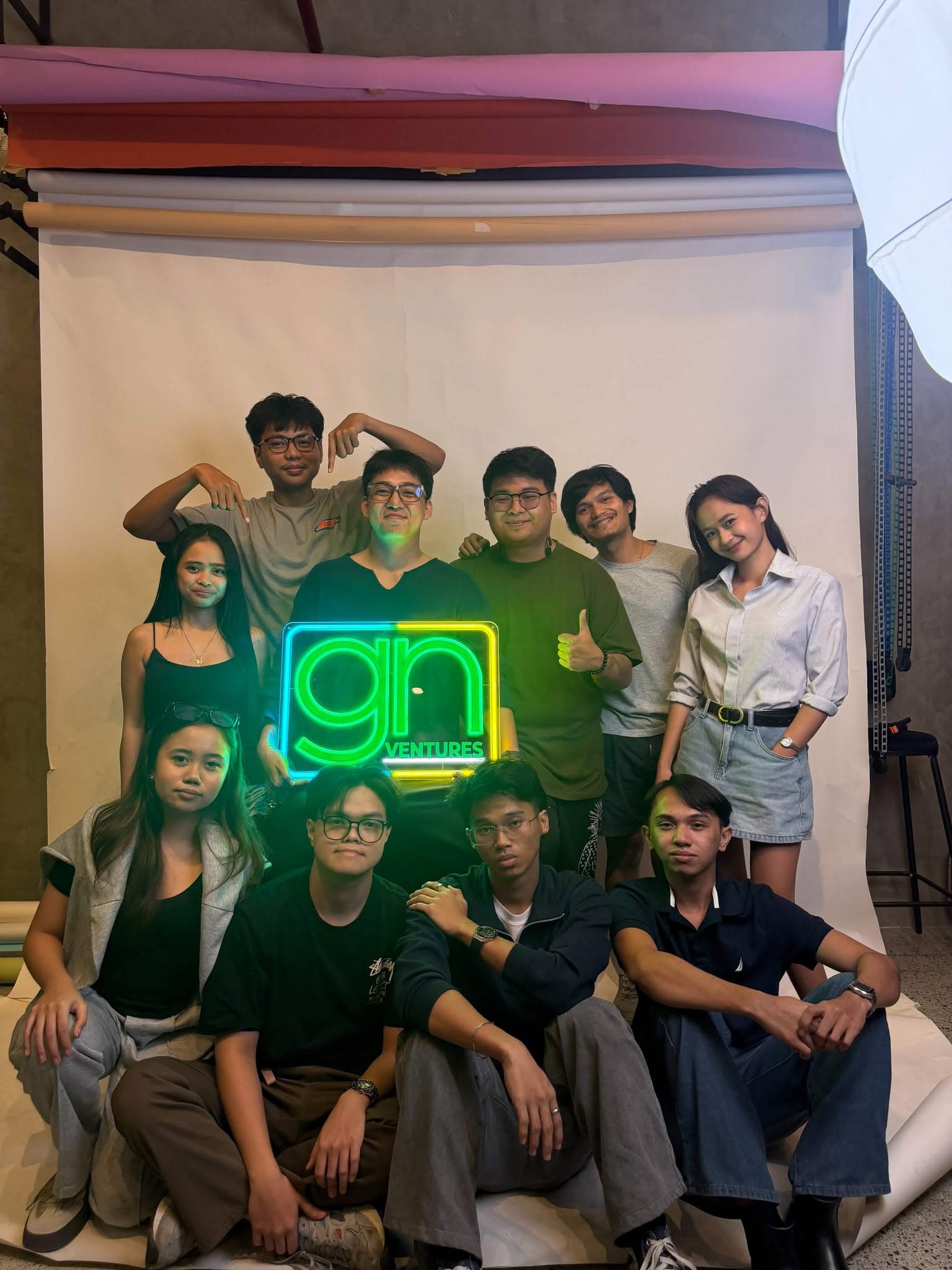 The GN Labs team gathered around a glowing gn Ventures sign